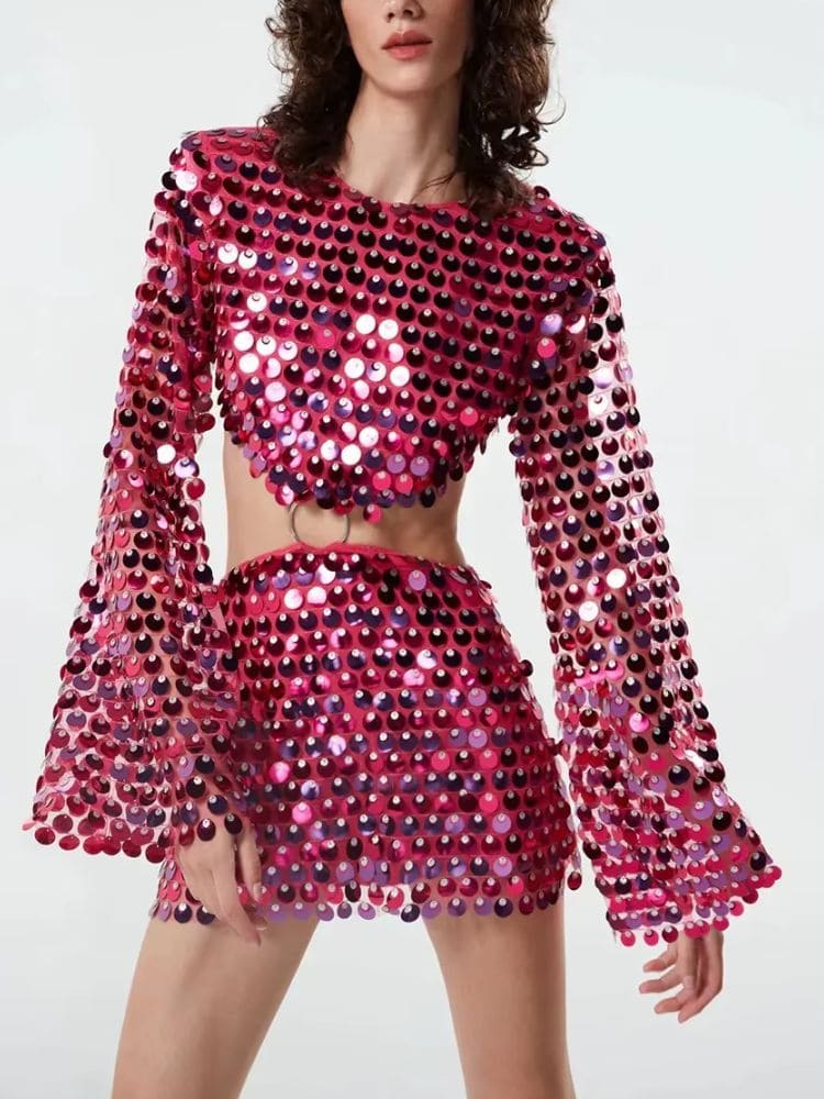 Modelo de frente usando vestido curto rosa com paetês e manga longa – Moda Origem